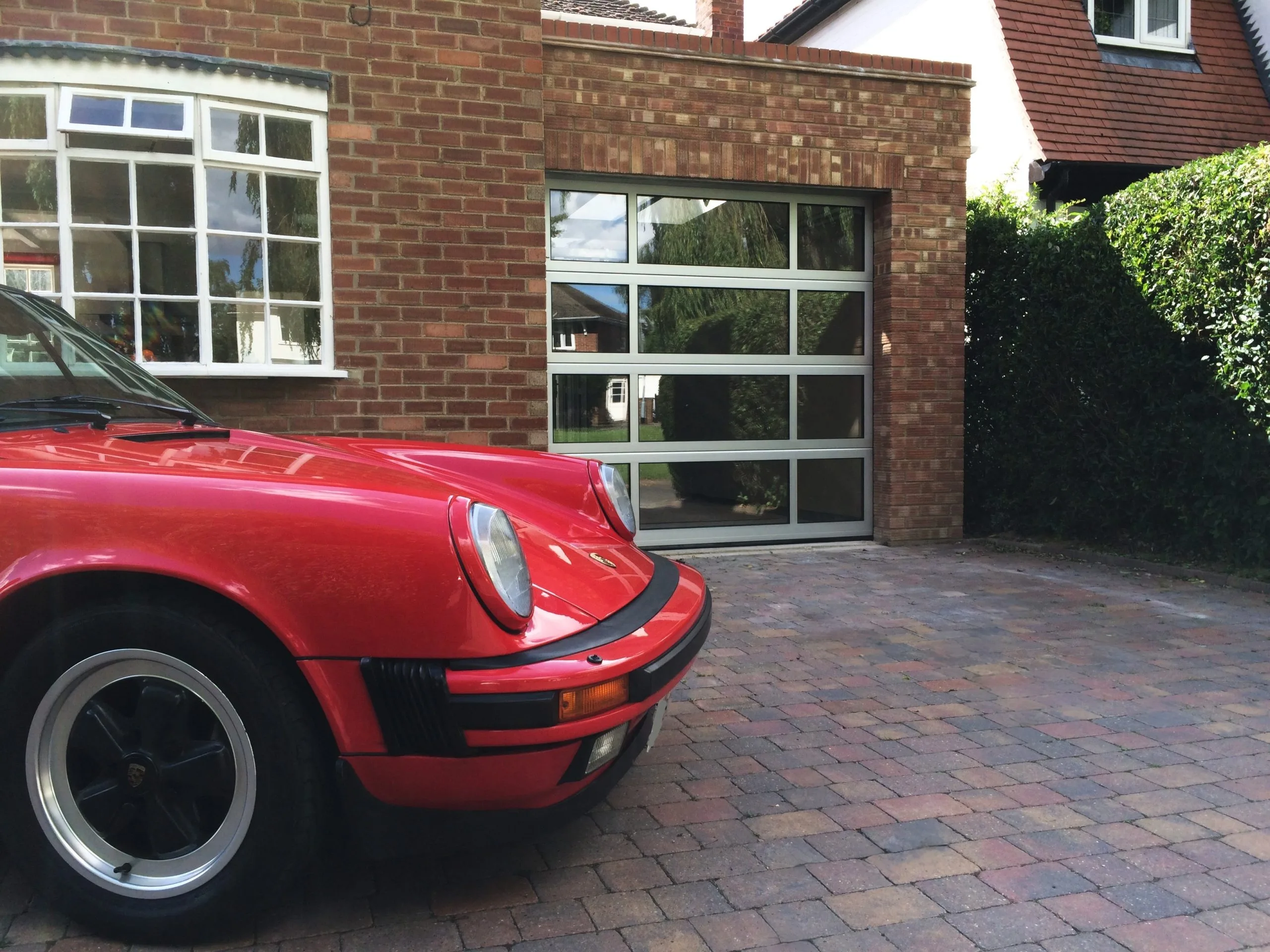 sectional_garage_door_glazed_red_car