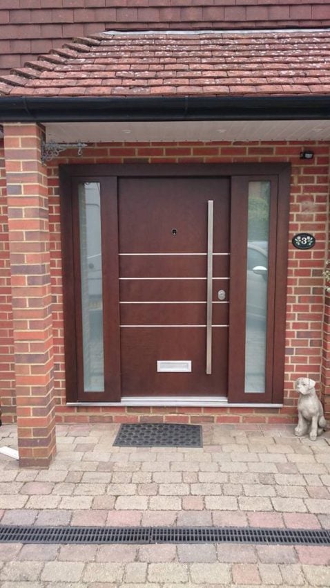 Glazed panels and brushed steelwork make this security door stand out for all the right reasons